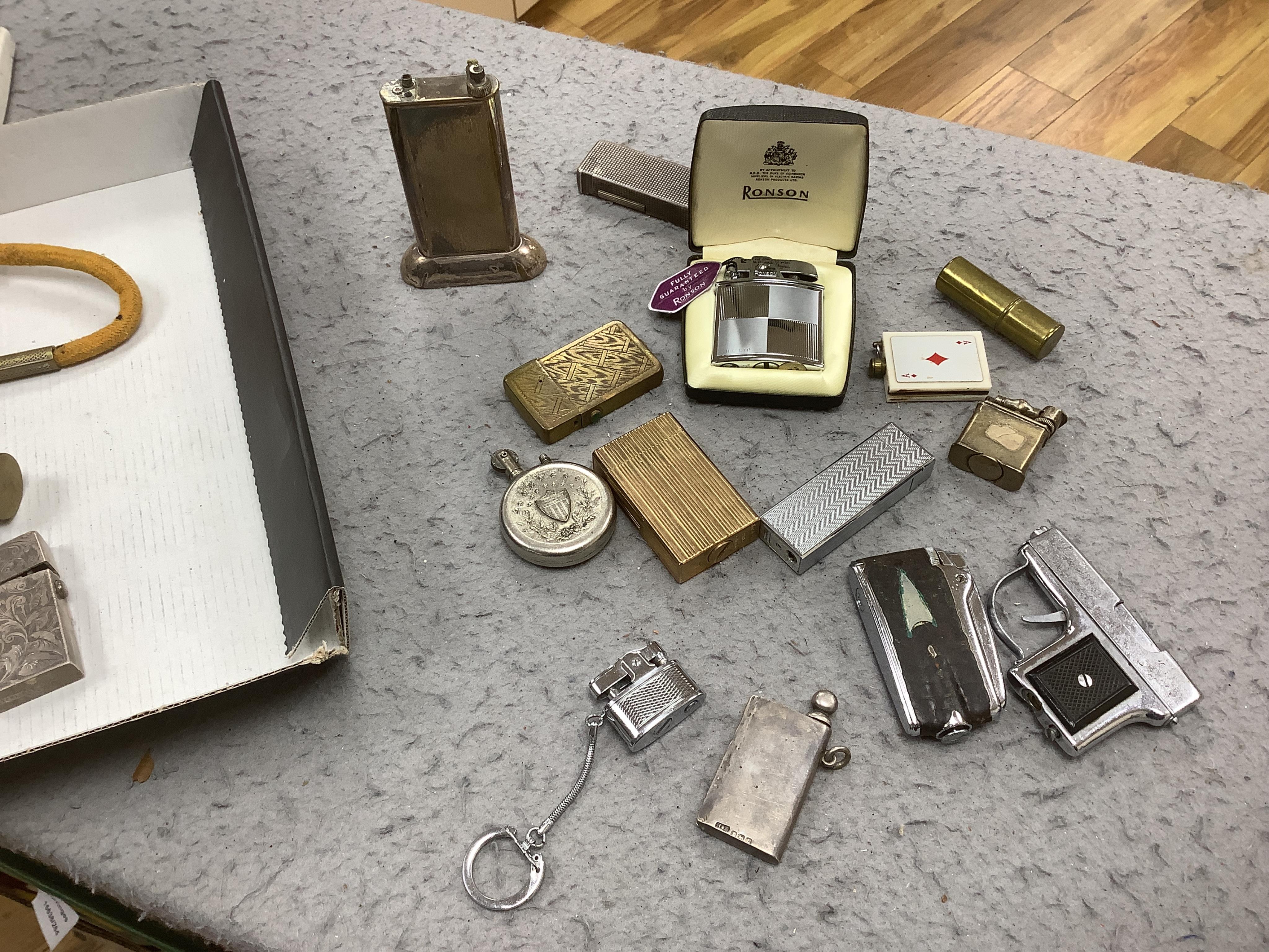 A collection of assorted cigarette lighters, including a large figural lighter, largest 23cm high. Condition - variable